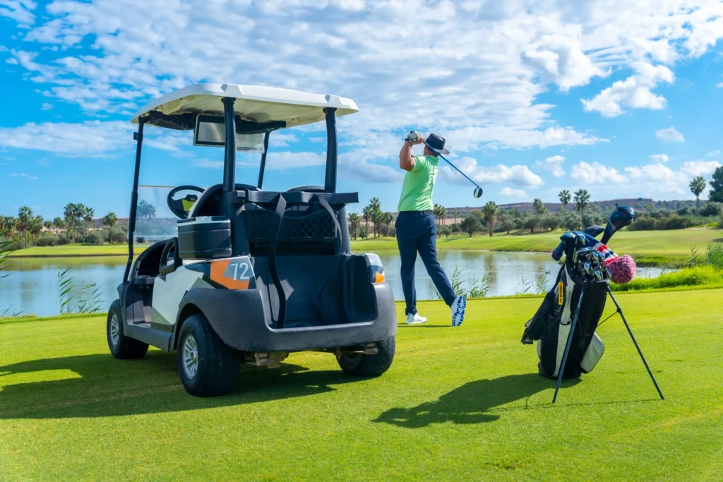 A golfer playing right next to his card on the field