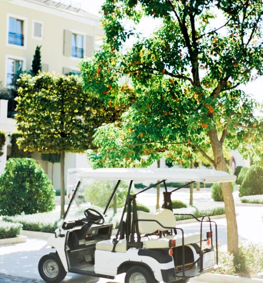 White golf cart parked on the sidewalk White golf cart parked on the sidewalk